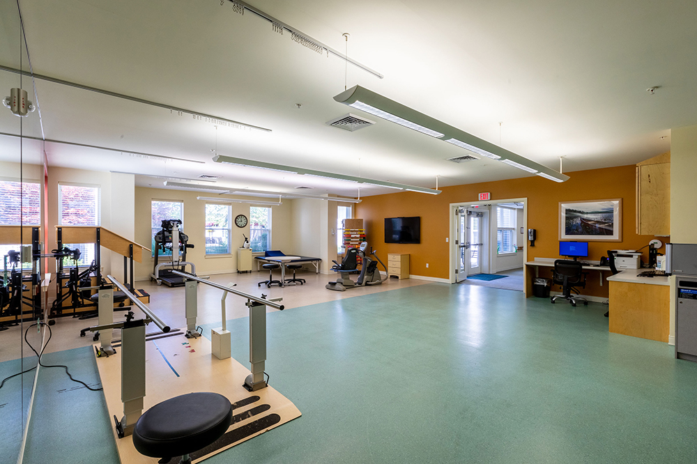 Rehabilitation gym with exercise equipment and therapy areas