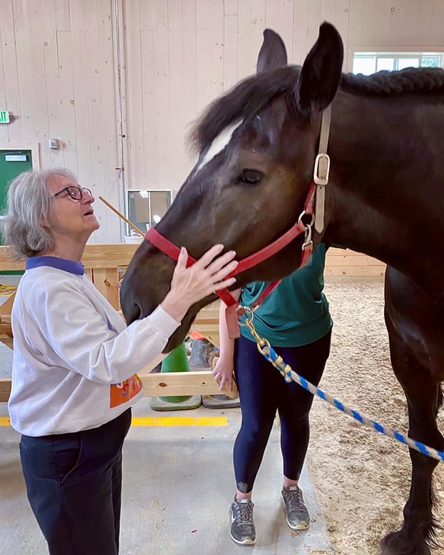 Resident interacting with a therapy horse indoors