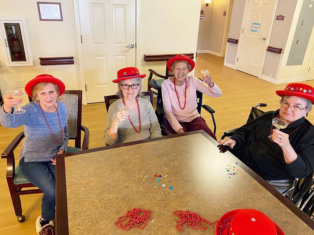 Residents celebrating with drinks in a common area
