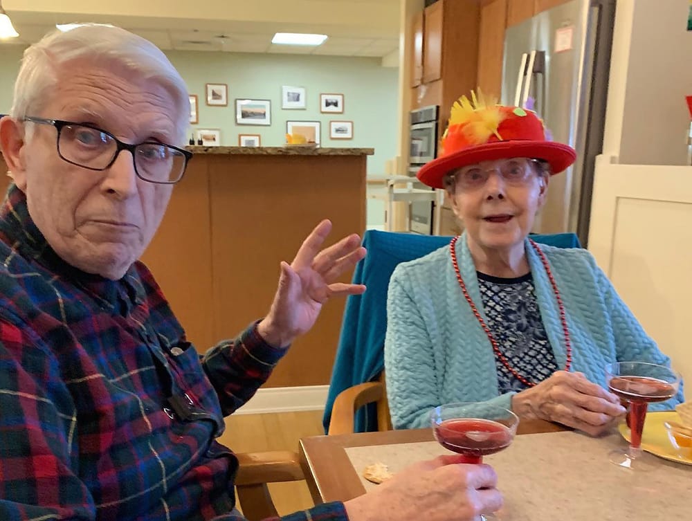 Two residents enjoying drinks together in a social setting
