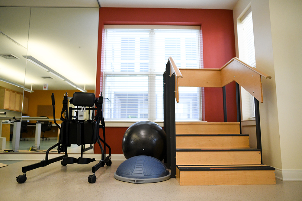 Therapy space with exercise equipment and stairs