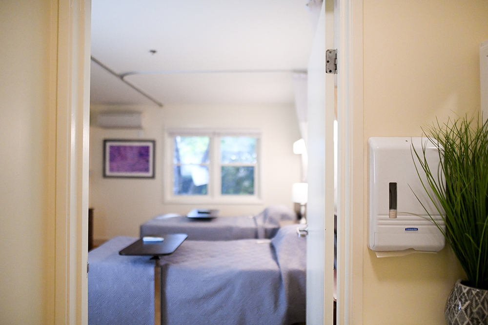 A view into a private resident room with beds