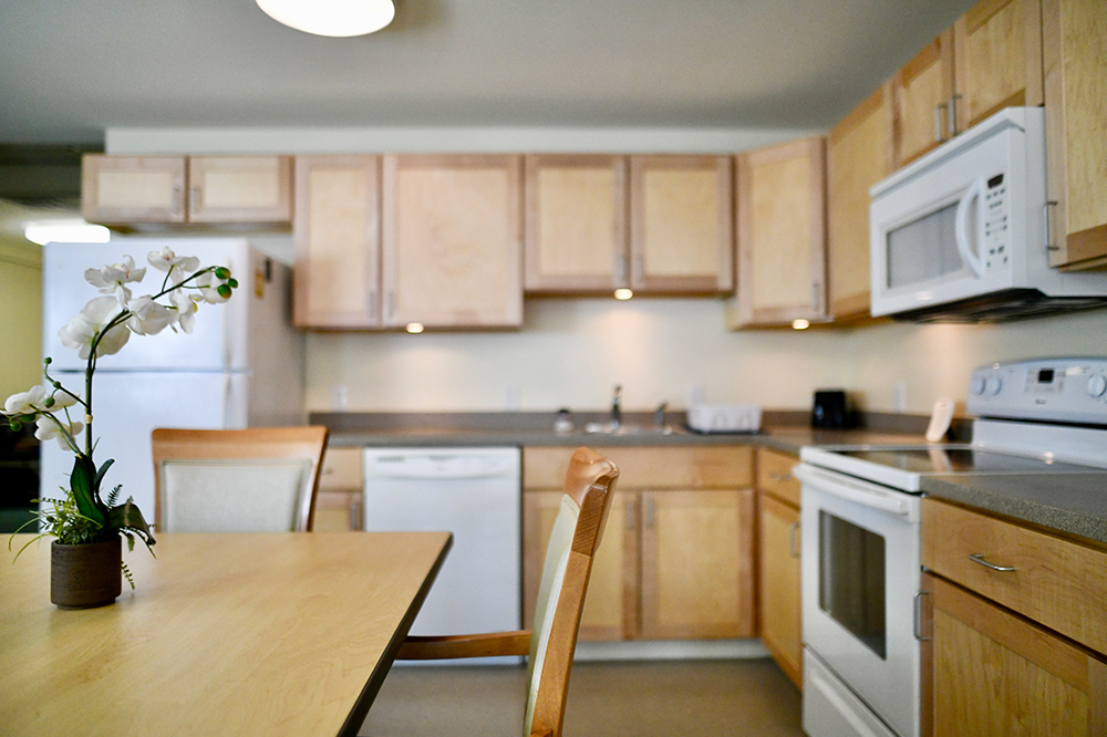 Modern kitchen space with wooden cabinets and table