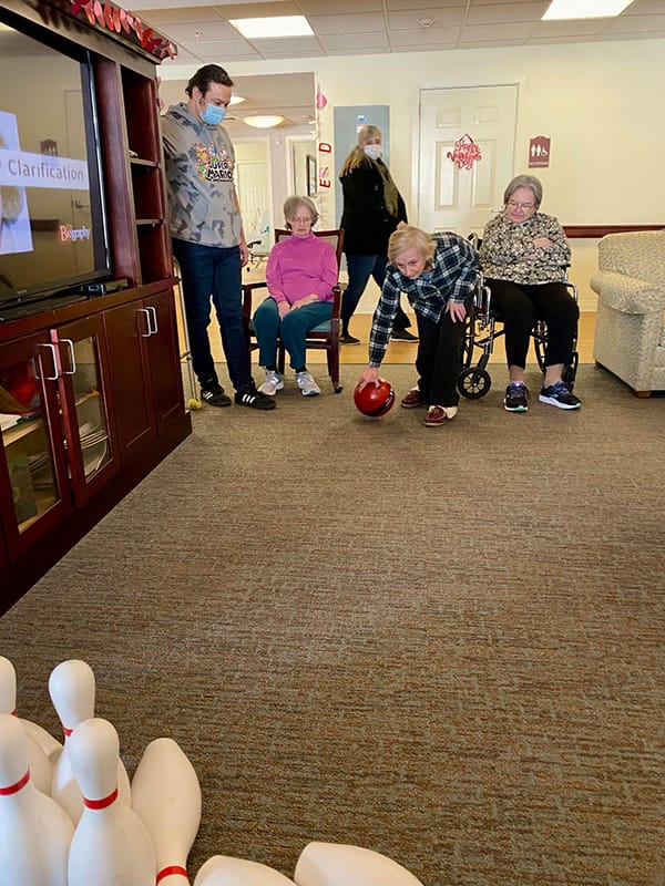 Residents enjoying a bowling activity in the common area