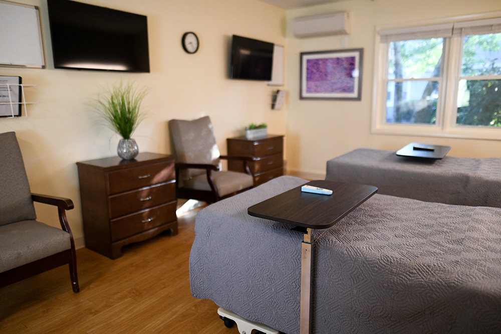 Cozy resident bedroom with two beds and seating area