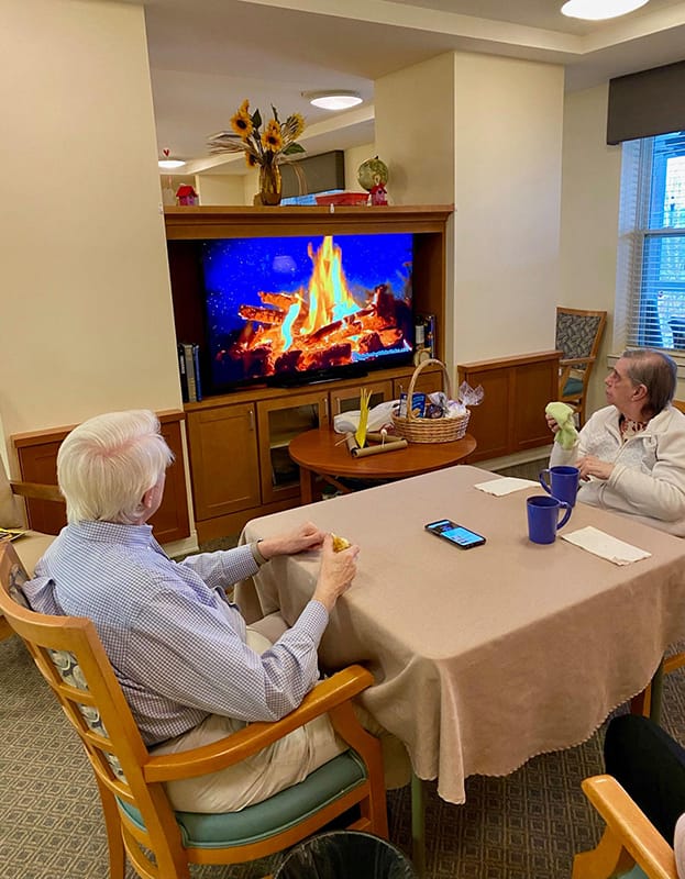 Two residents enjoying a cozy setting in a common area