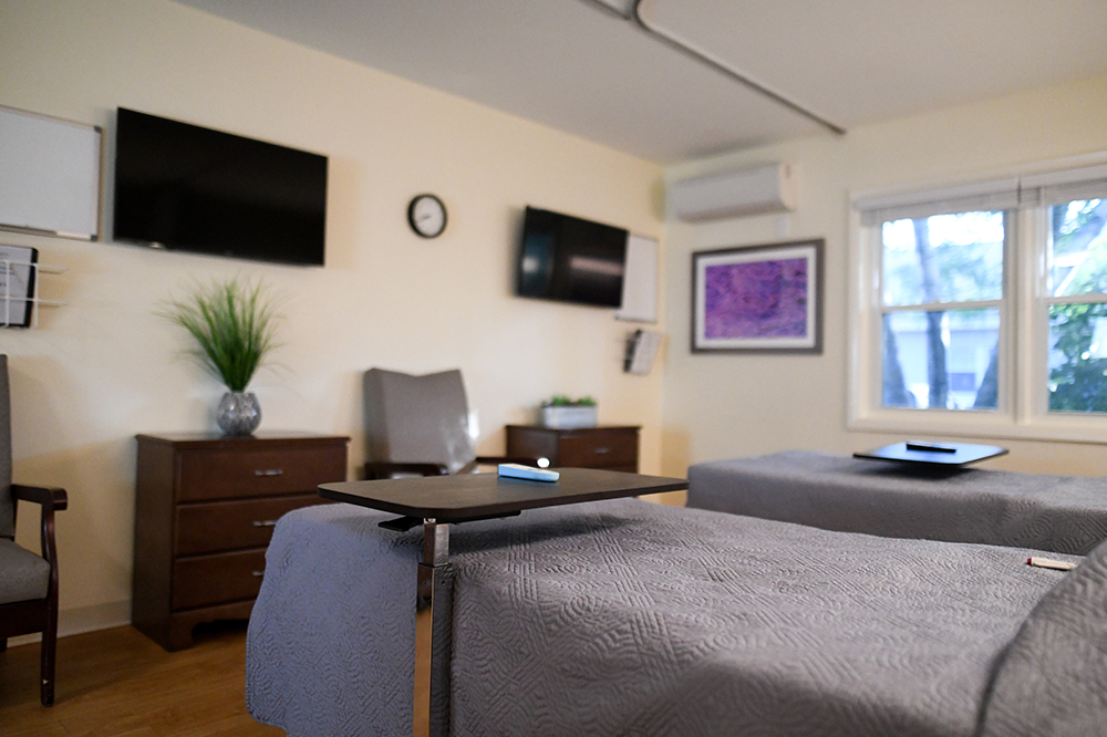 Interior view of a resident room with beds and furnishings