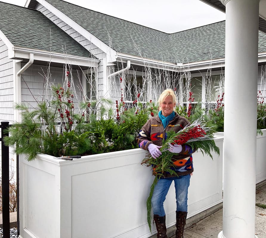 A staff member arranging flowers outside the facility