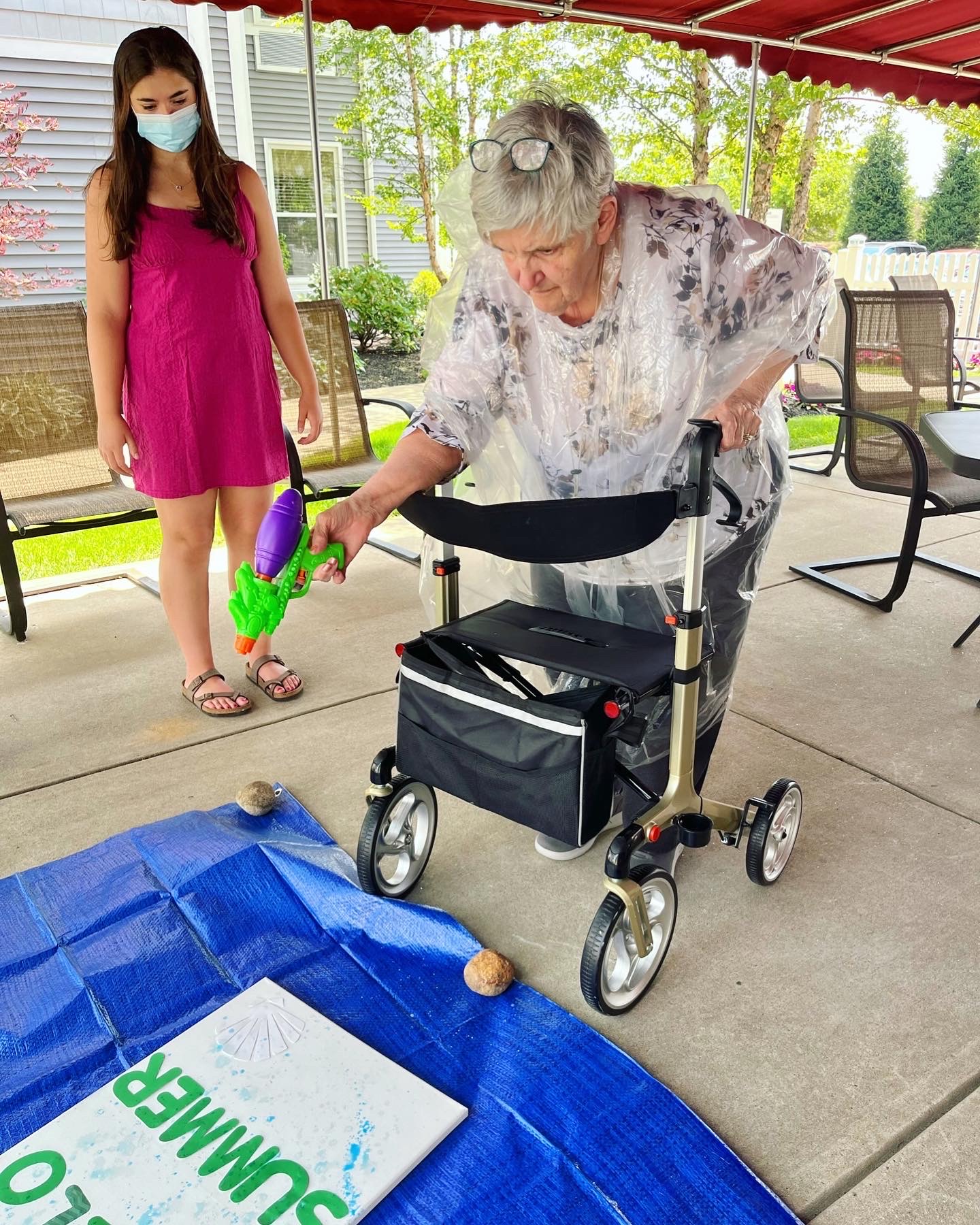 Resident enjoying a summer activity outside with a water toy