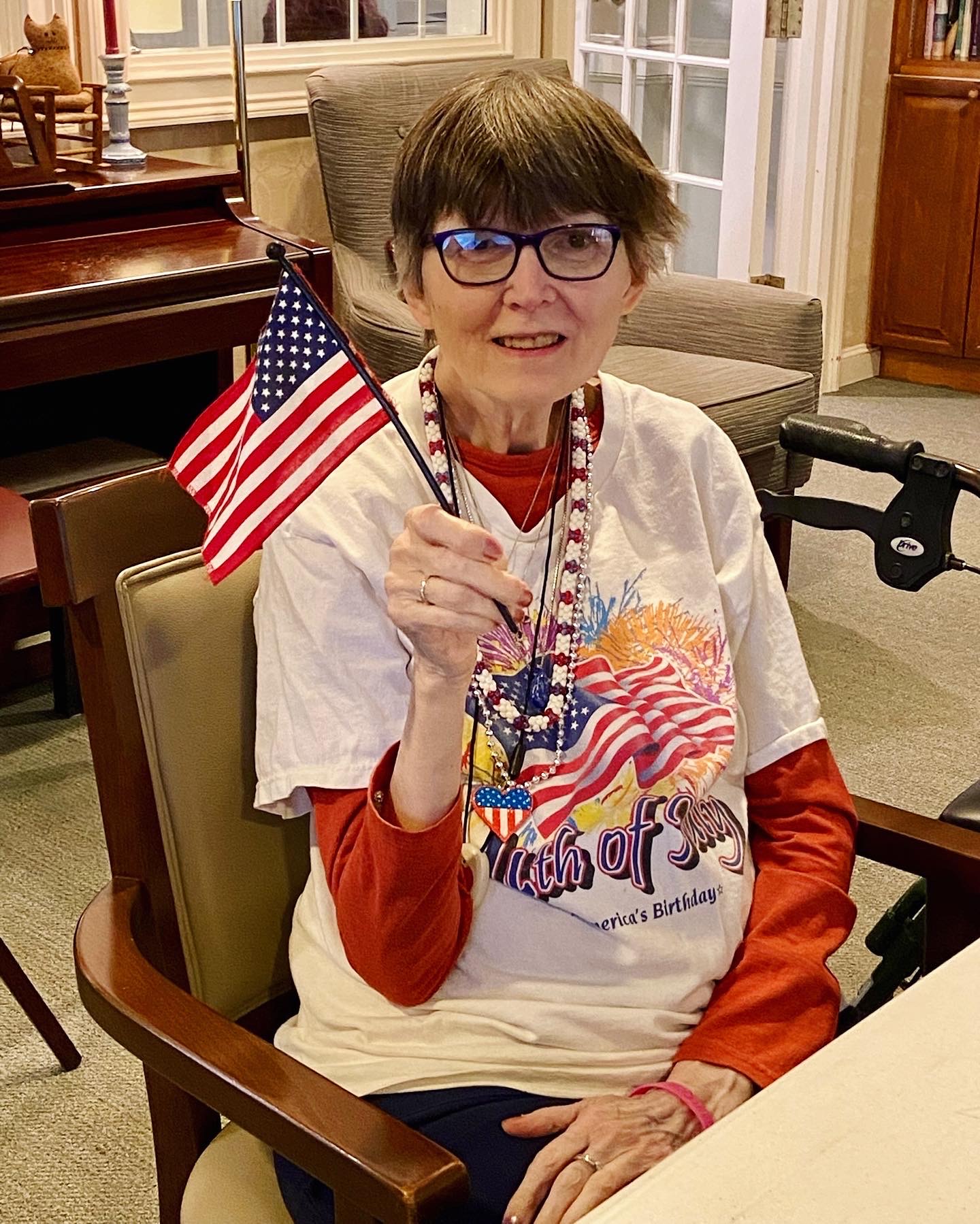 Resident celebrating with an American flag.