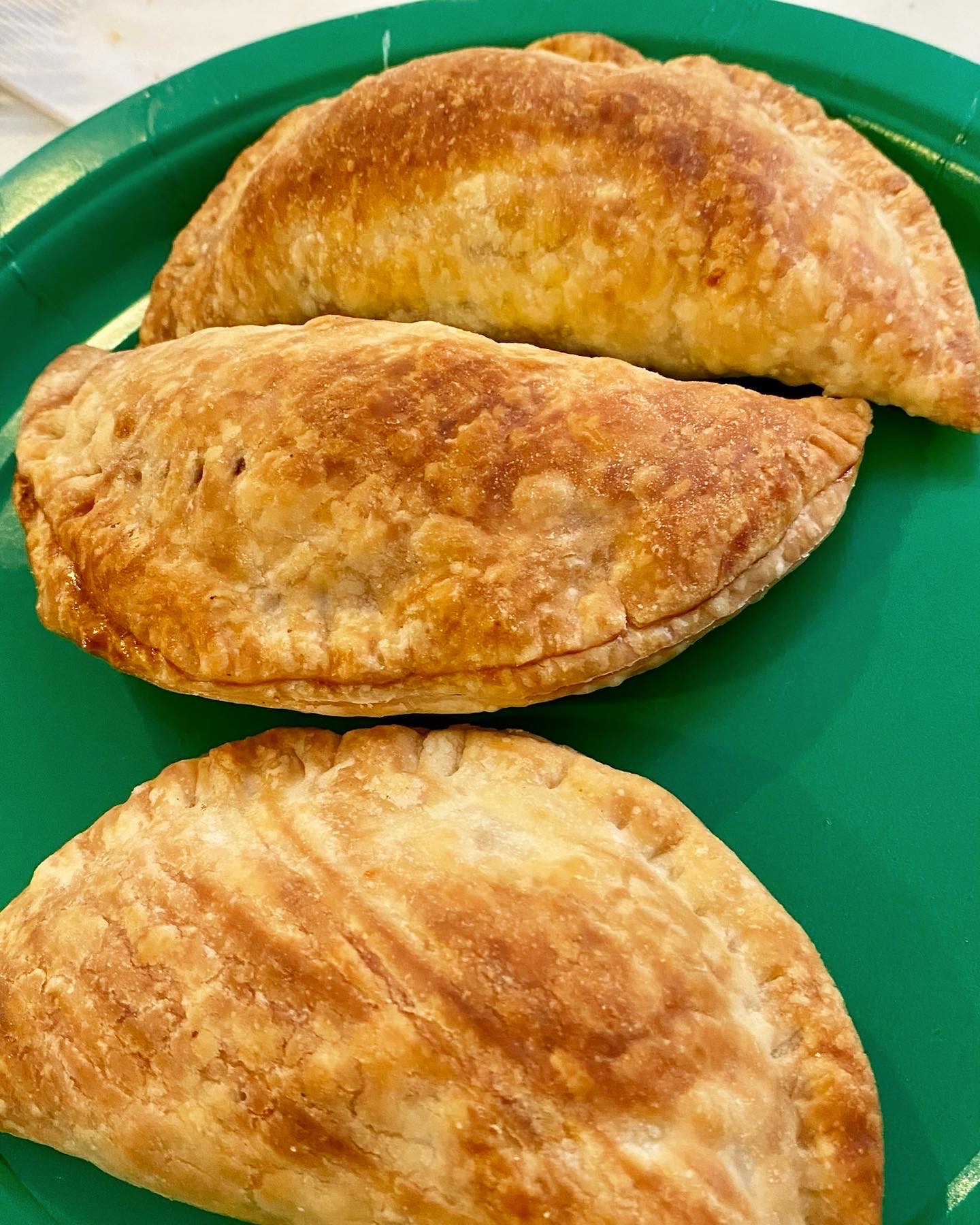 Three delicious pastries on a green plate