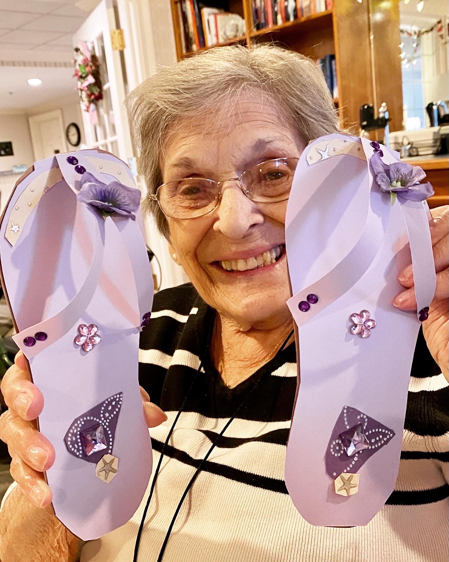 Resident proudly showing decorated flip-flops