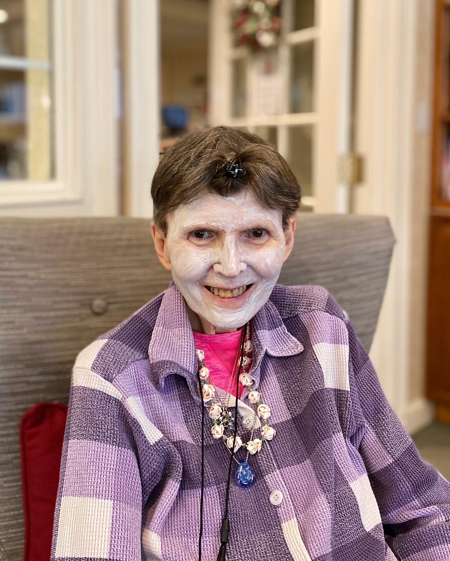 Resident smiling in a cozy indoor setting