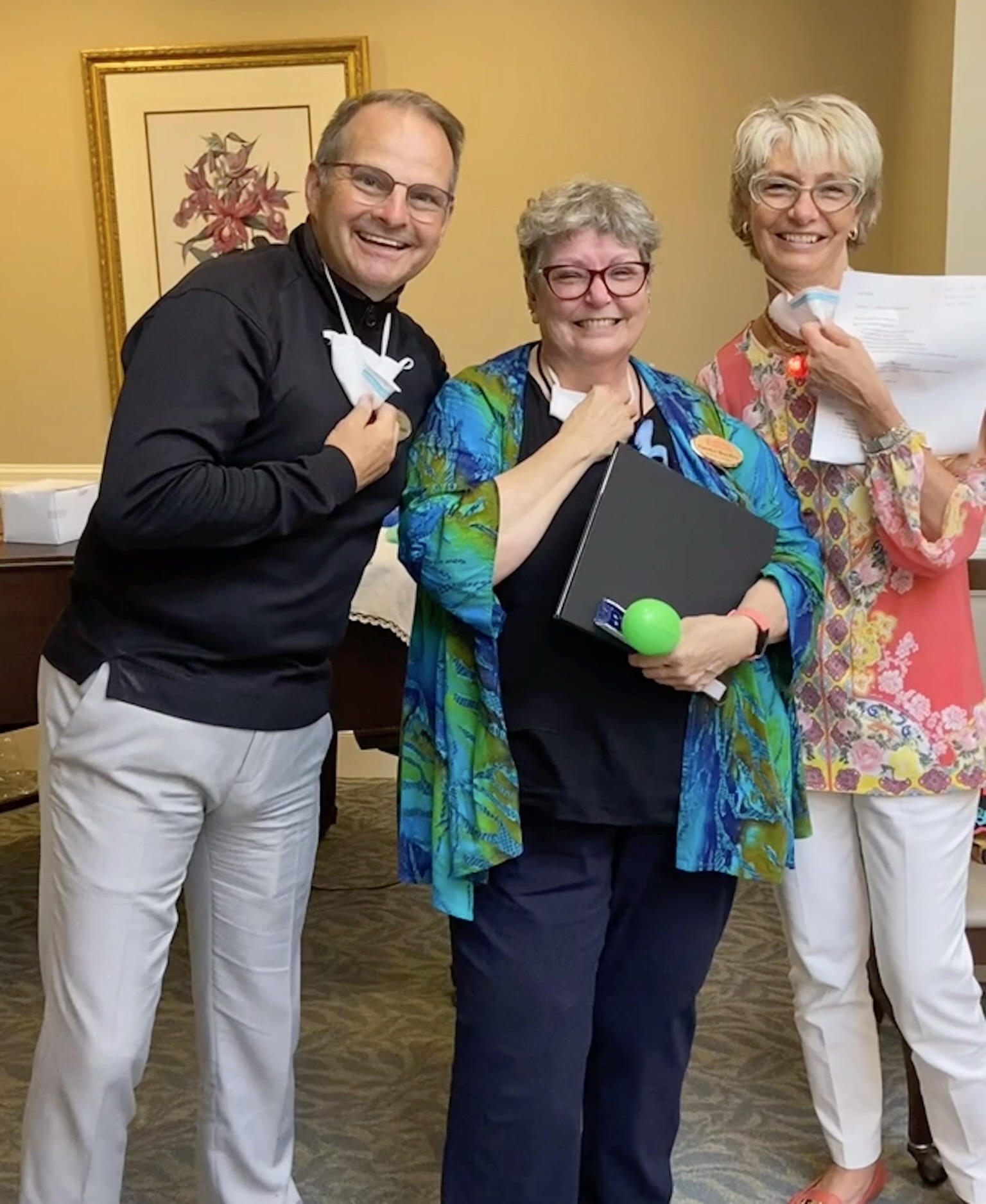 Staff and residents smiling in a common area