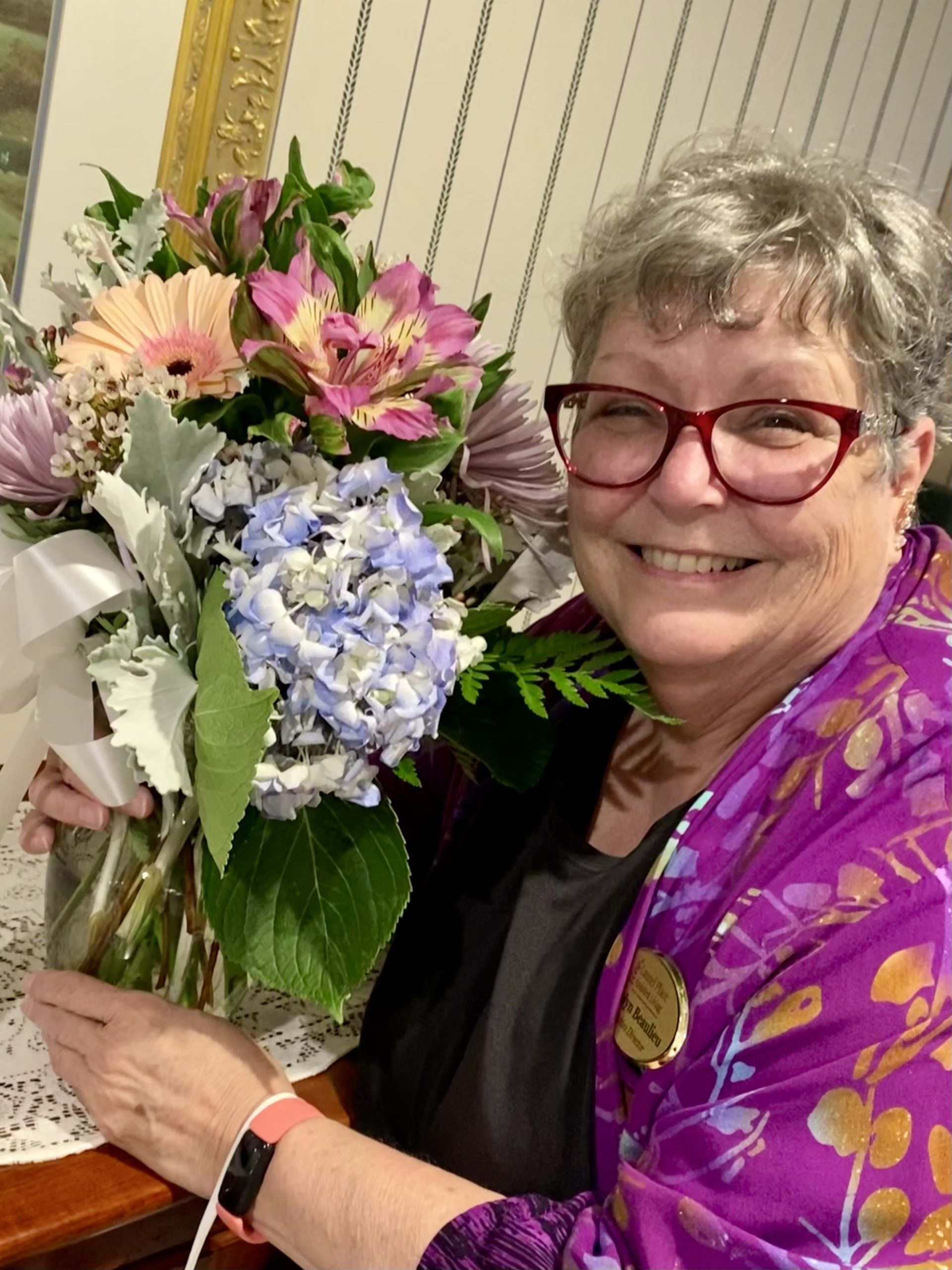 Resident smiling with a bouquet of flowers