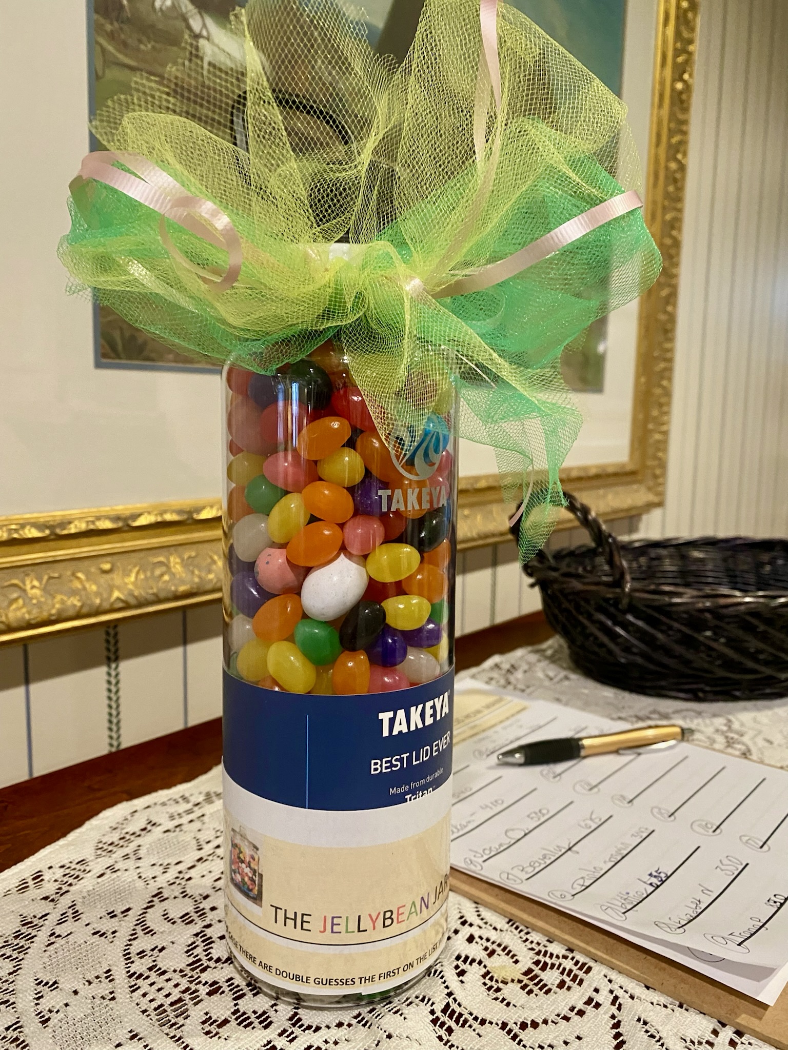 Container of jelly beans with a ribbon decoration
