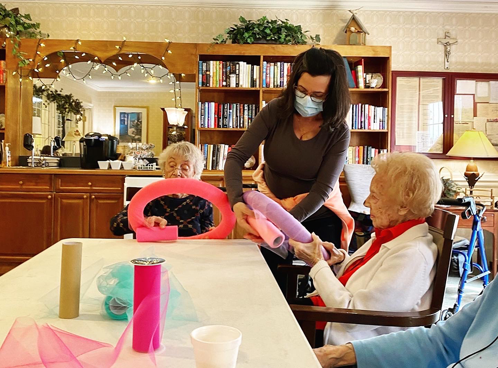 Residents engaging in an activity with staff assistance