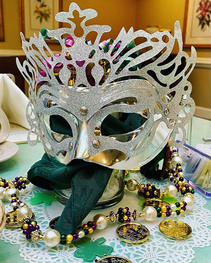 A decorative mask with beads on a table
