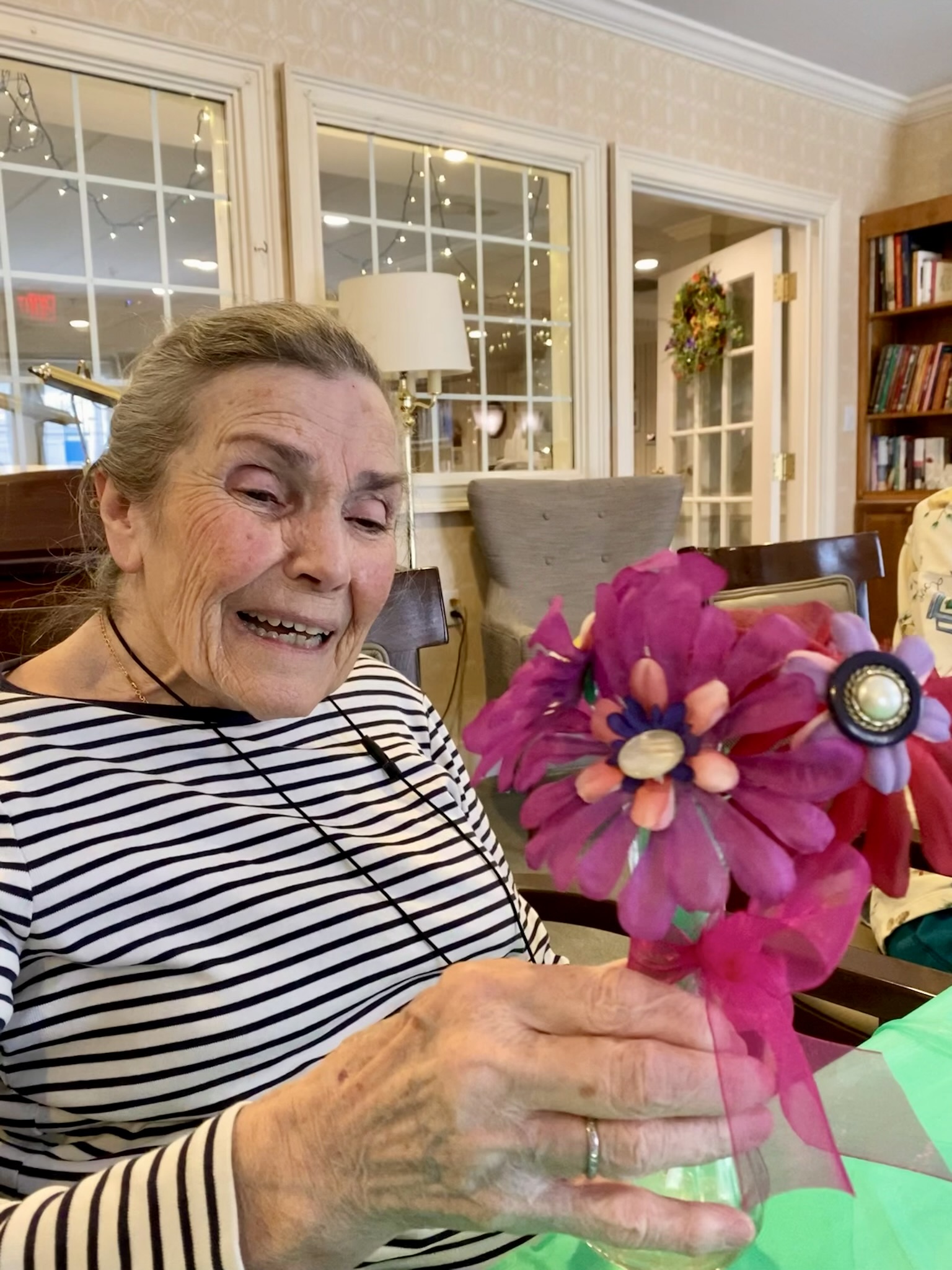 Resident enjoying a flower arrangement activity
