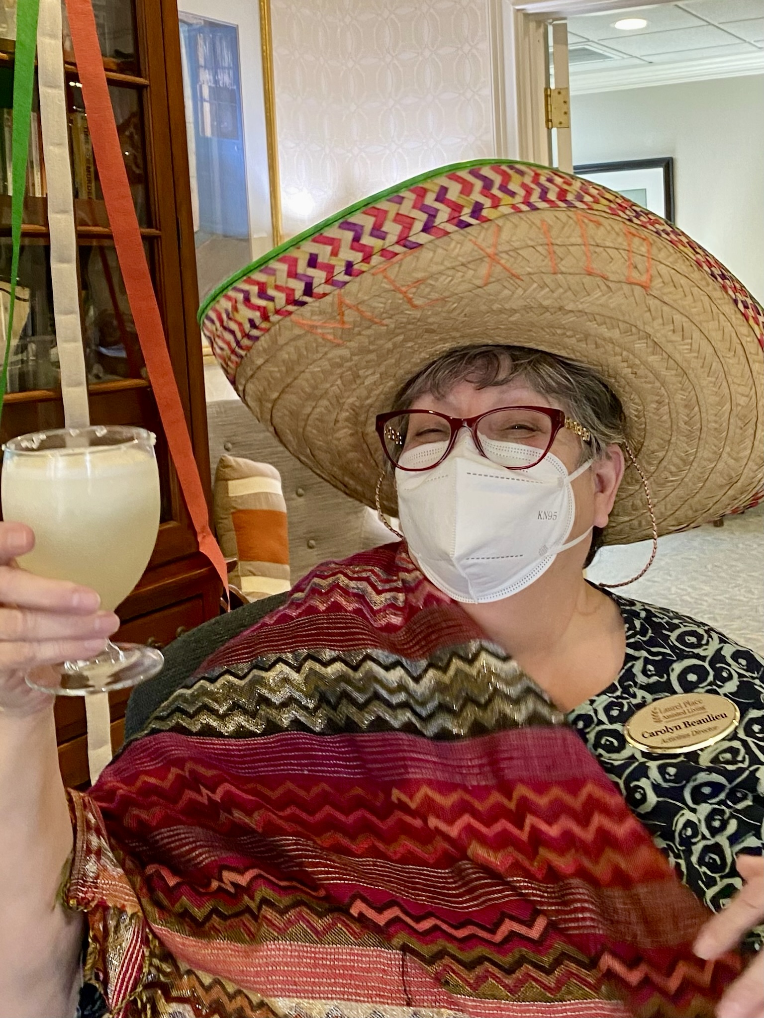 Staff member celebrating with a festive drink and sombrero