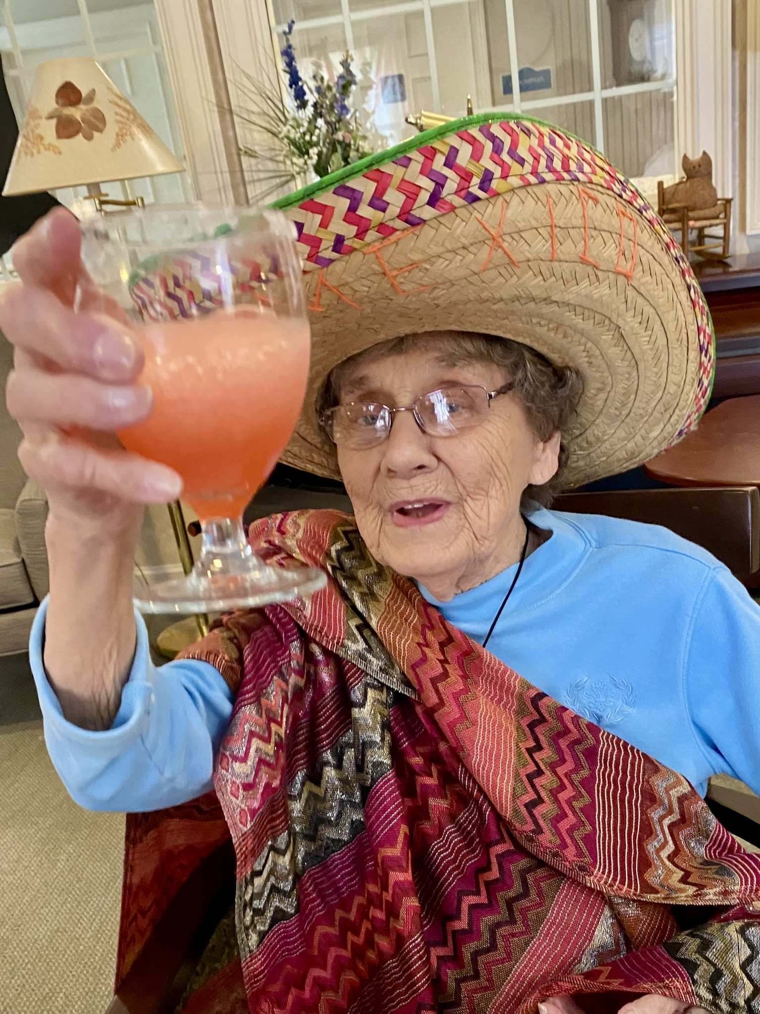 Resident celebrating with a drink in festive attire