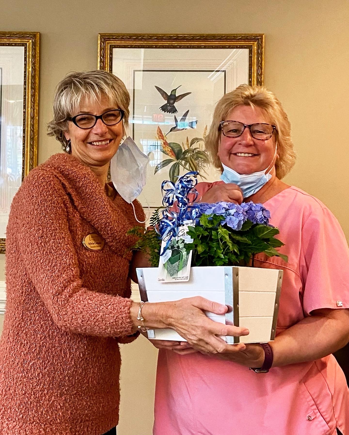 Staff member receiving a flower gift in a common area