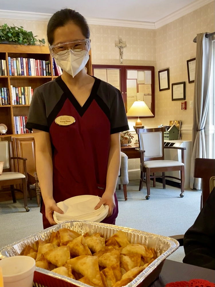 Staff serving a tray of food in a common area