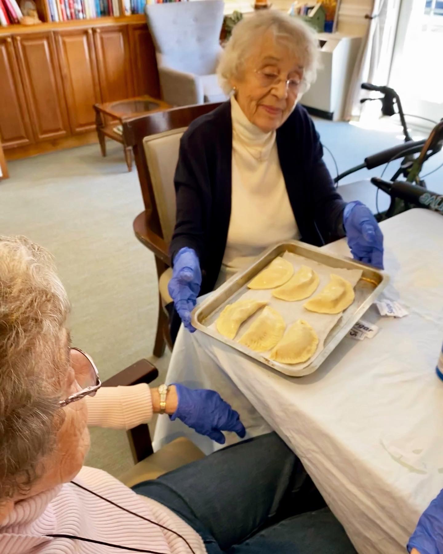 Residents preparing food together in a common area