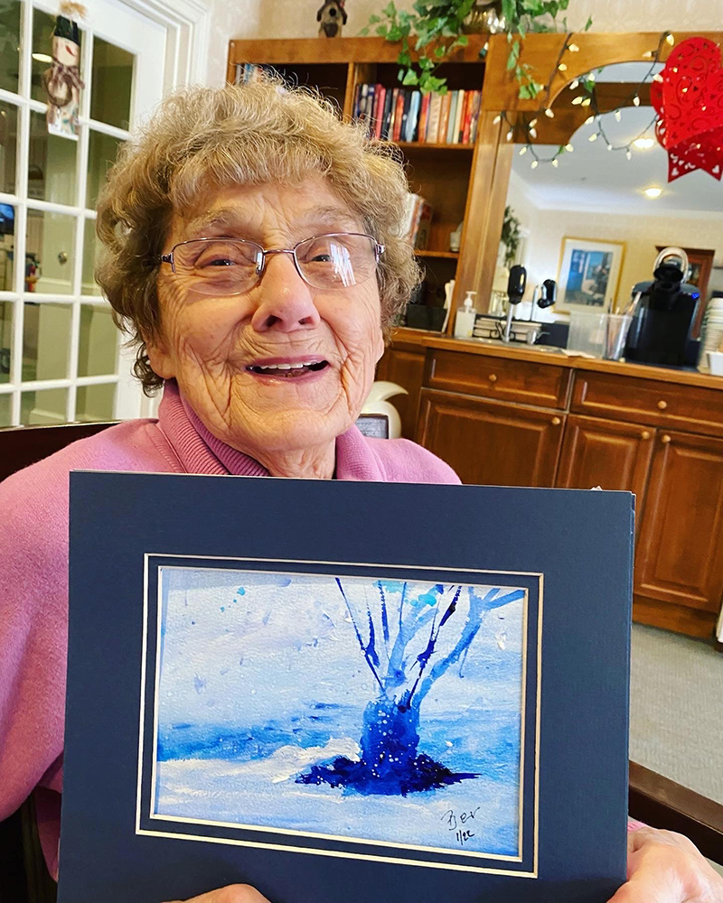 Resident proudly displaying their art in a common area