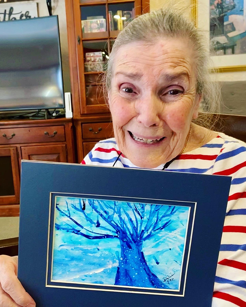 Resident proudly displaying artwork in a common area
