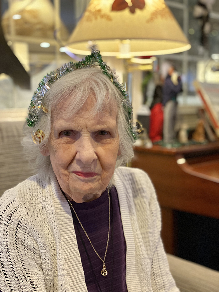 Resident wearing festive headband in a cozy setting