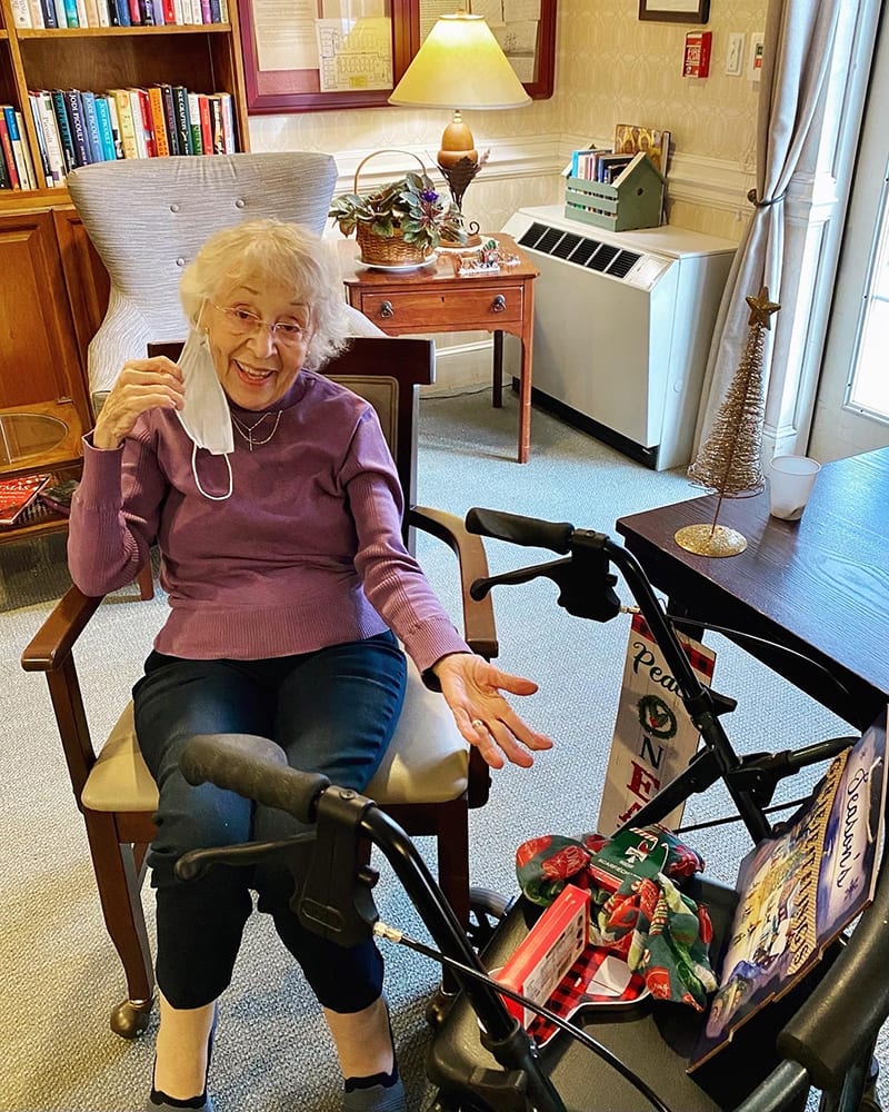 Resident enjoying time in a common area with festive decor