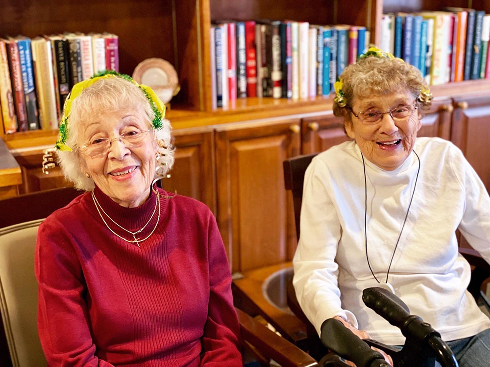 Two residents smiling together indoors
