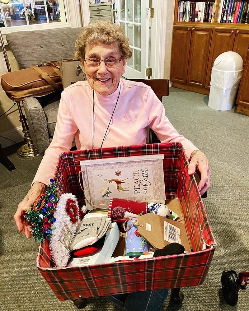 Resident smiling with a decorated box of items