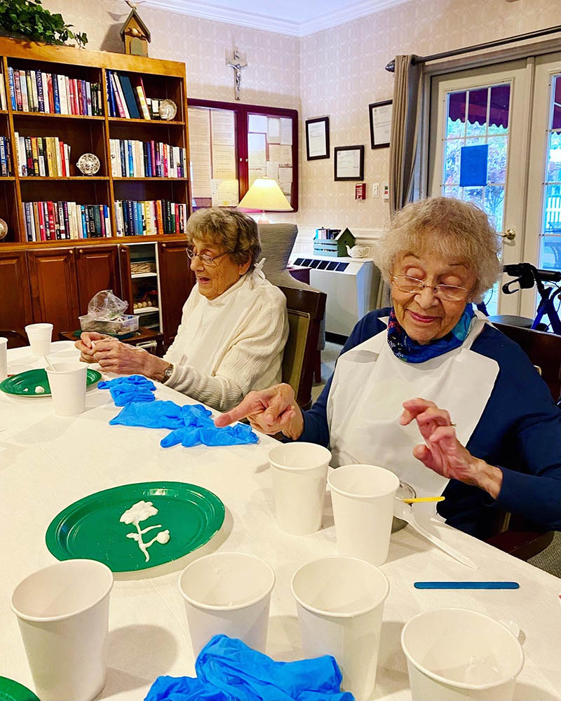 Residents engaging in an art activity at a table