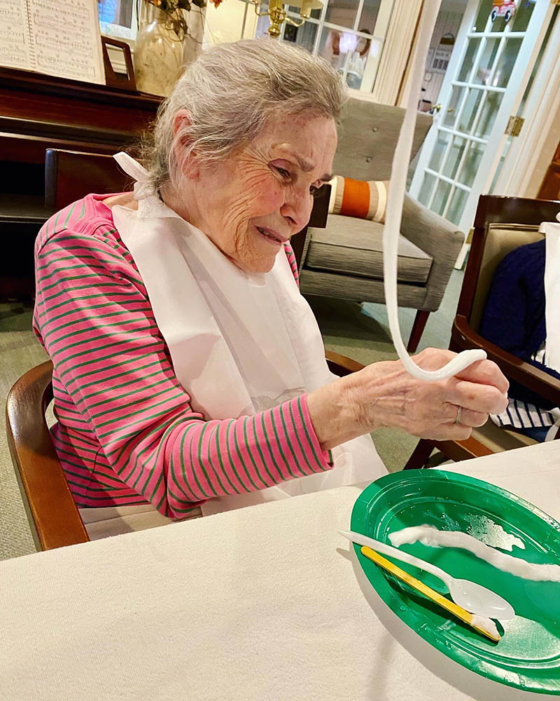 Resident enjoying a hands-on activity in an interior space