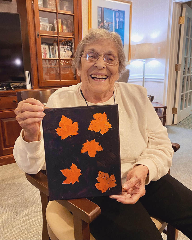 Resident showing off an art project in a common area