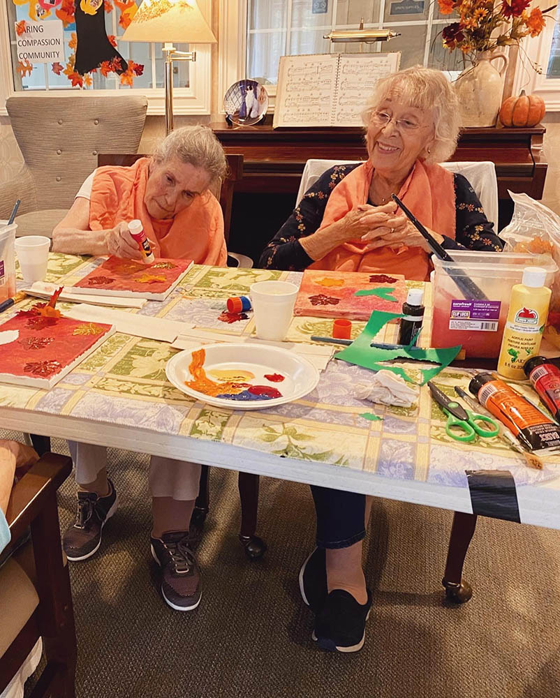 Residents engaged in an art activity at the facility