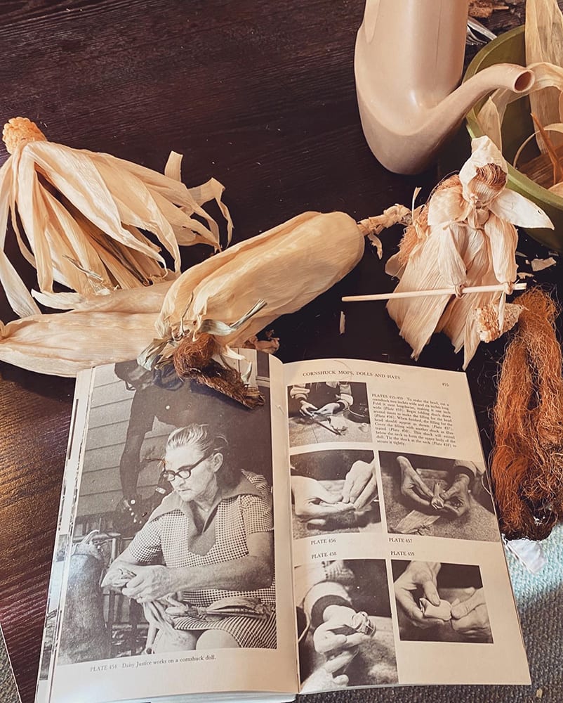 An old book with pictures and corn decorations
