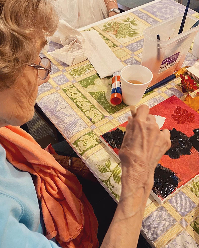 Resident painting in an arts and crafts activity