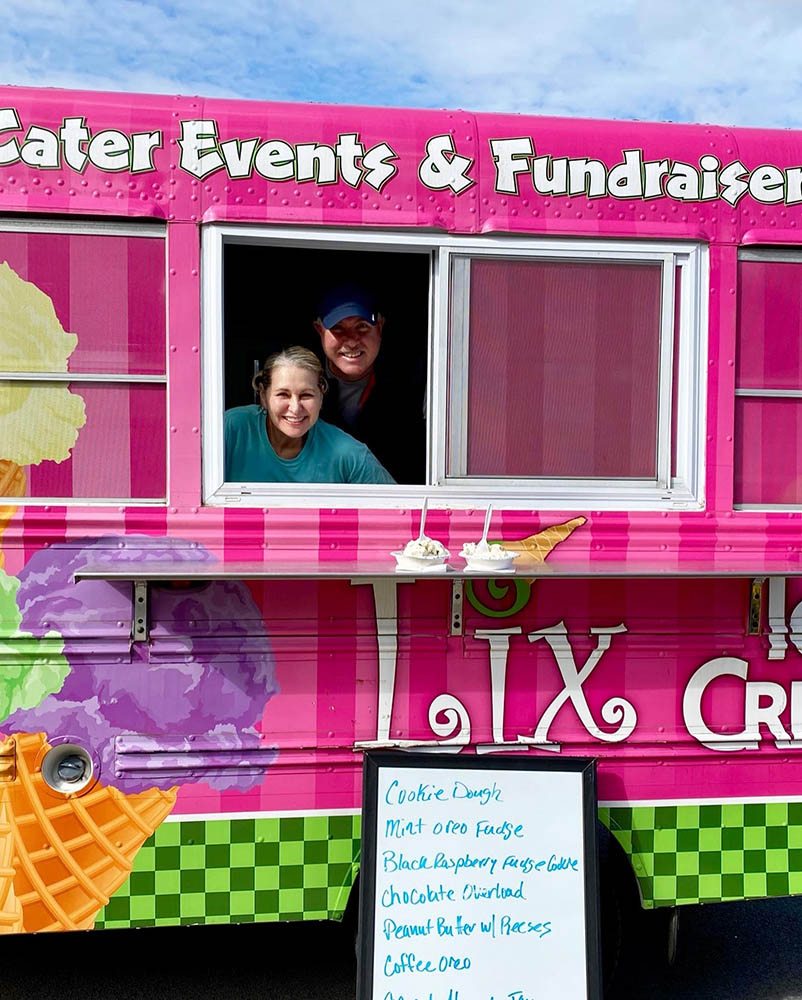 Employees serving ice cream from a food truck