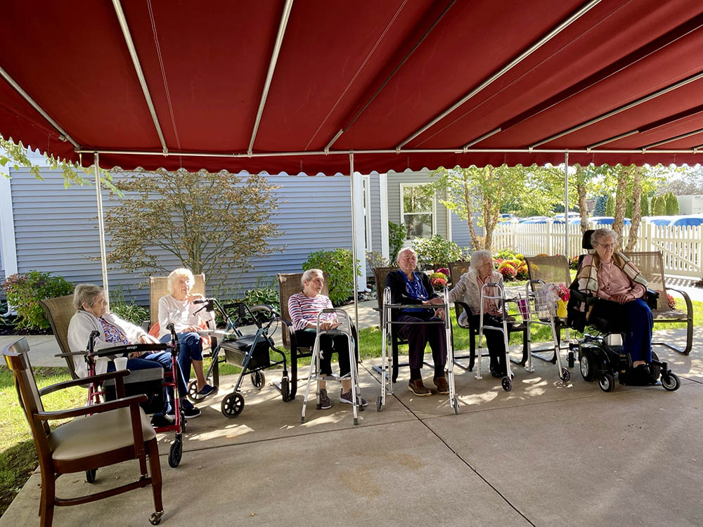 Residents enjoying time outdoors under a canopy