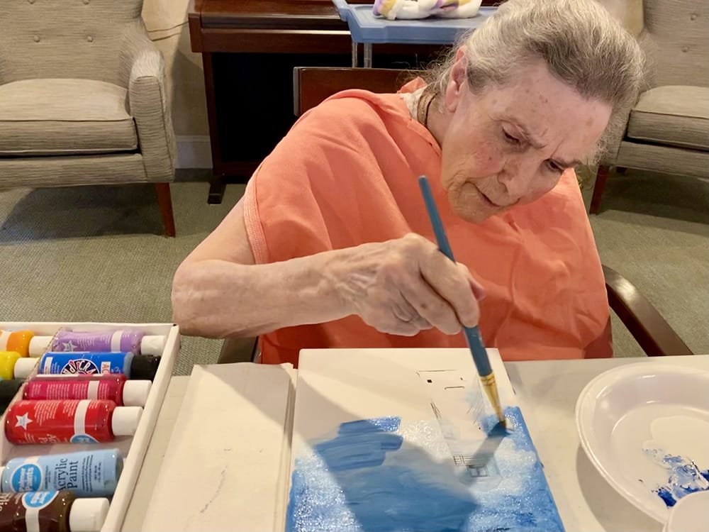 Resident painting during an art activity