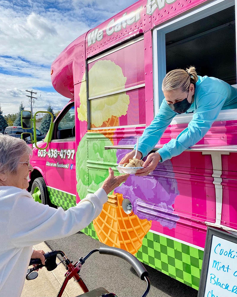 Resident receiving ice cream from a food truck