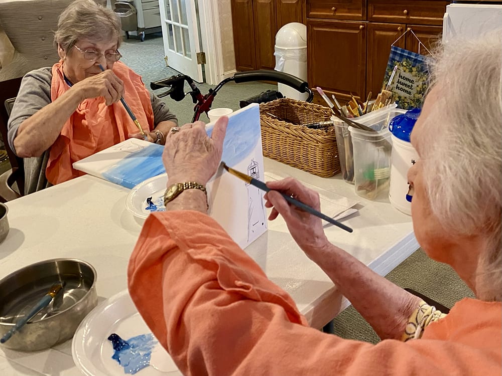 Residents participating in a painting activity