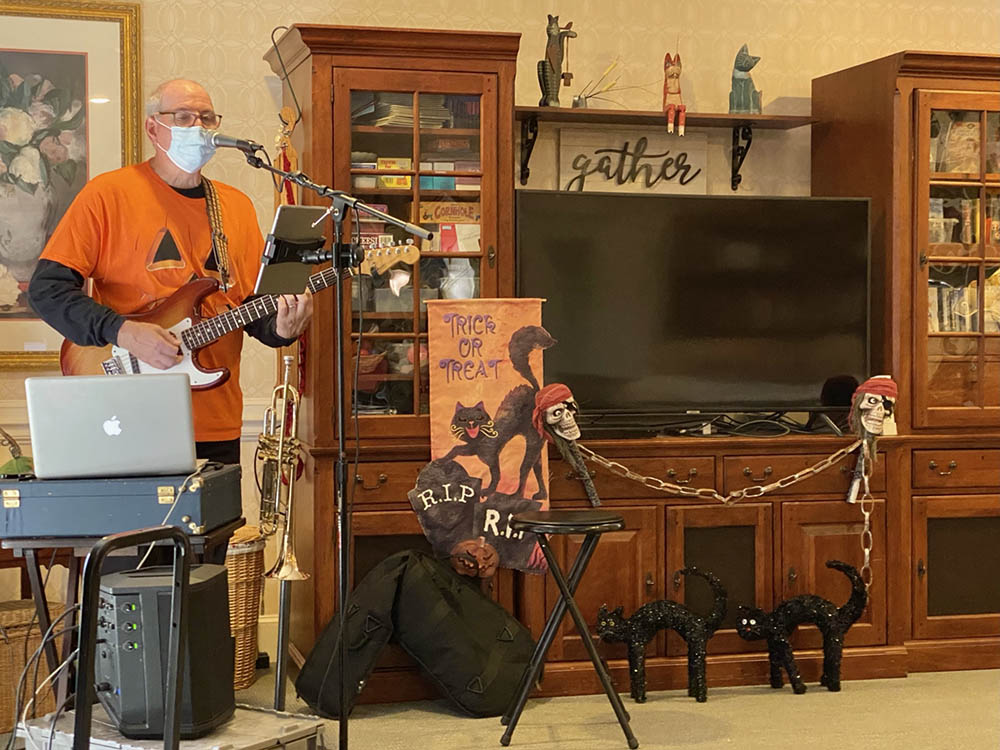 A musician performing for residents in a common area