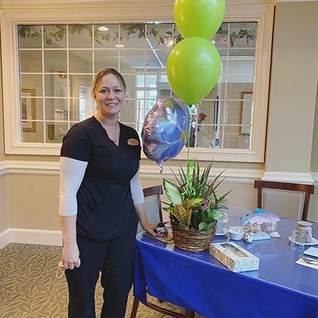 Staff member celebrating with decorations in an activity room