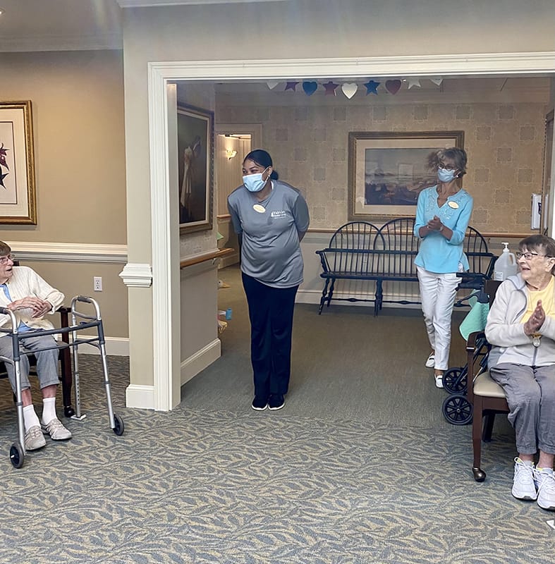 Residents and staff interacting in a common area