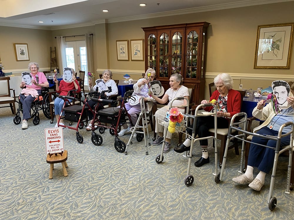 Residents participating in an Elvis-themed activity in a common area