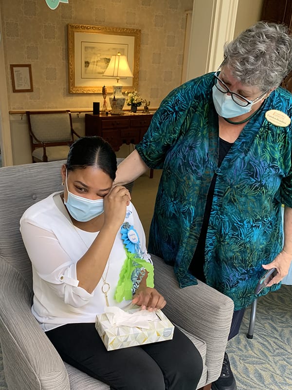Staff member comforting a resident during an emotional moment